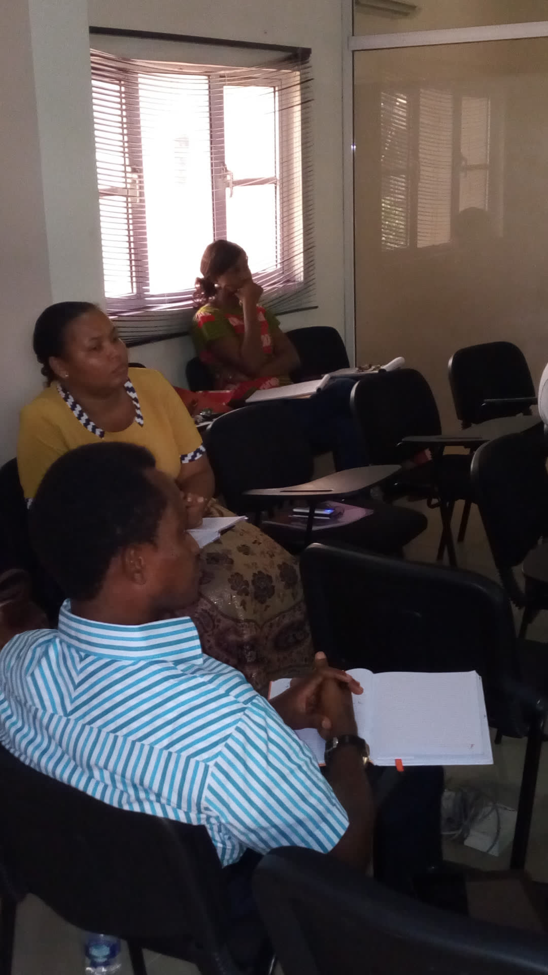 Professionals taking notes during an in-house learning session